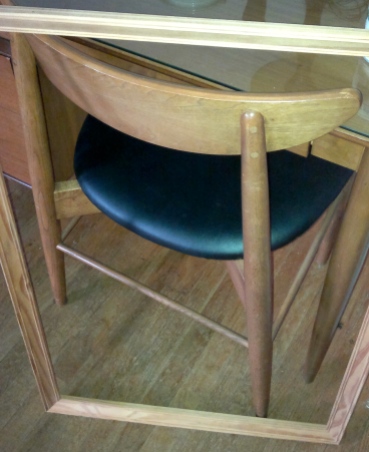 Frame leaning against table and chair